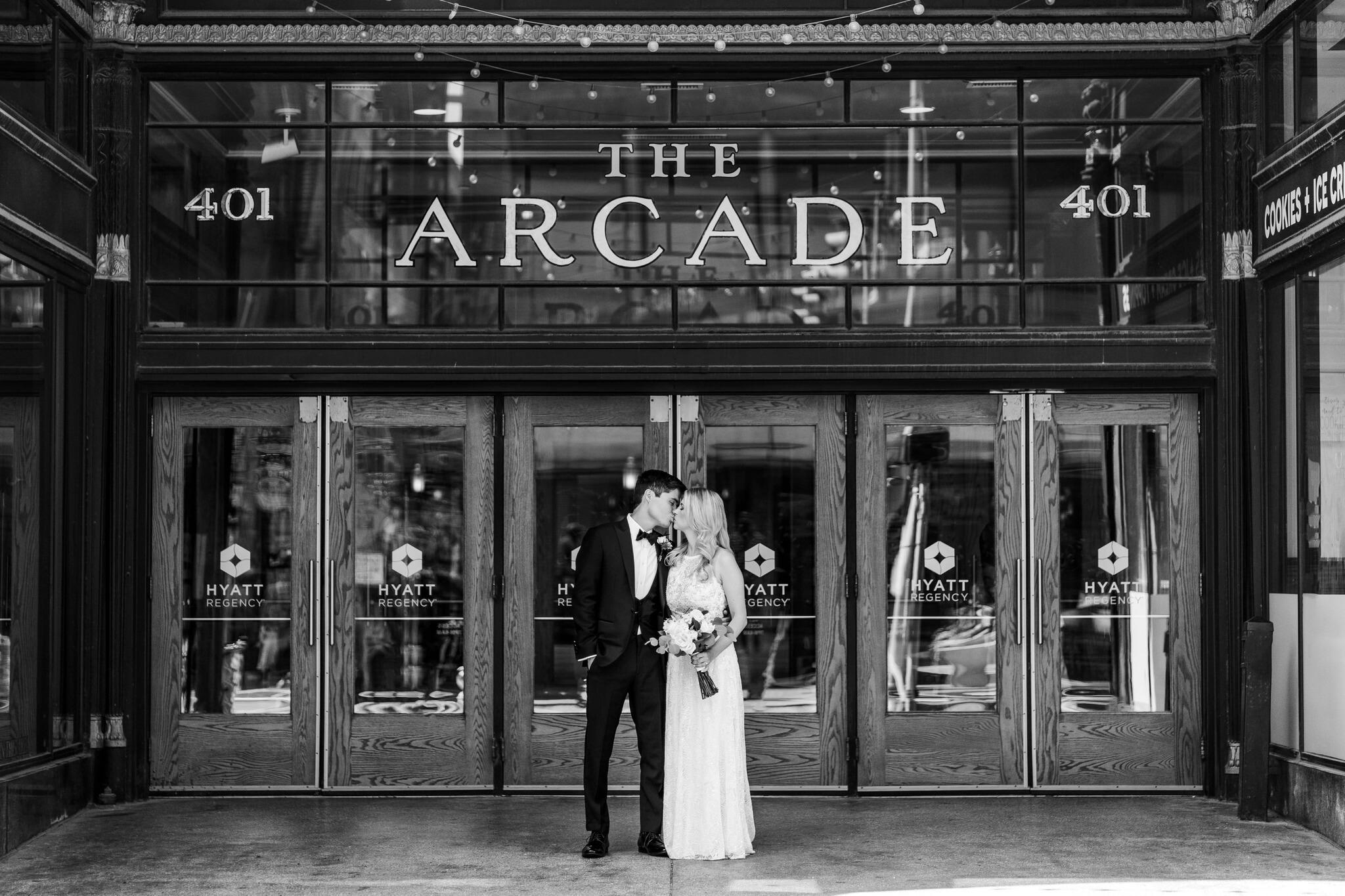 bridal photographs bride and groom kissing in front of The Arcade Cleveland
